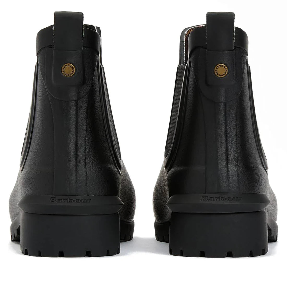 Rear view of a pair of Barbour Wilton Black Chelsea Wellingtons Women's Rainboots featuring chunky soles, pull tabs, tartan lining peeking out, and a small round gold detail on the back., 190375411423, 190375411546, 190375411614, 190375411768, 19037541185