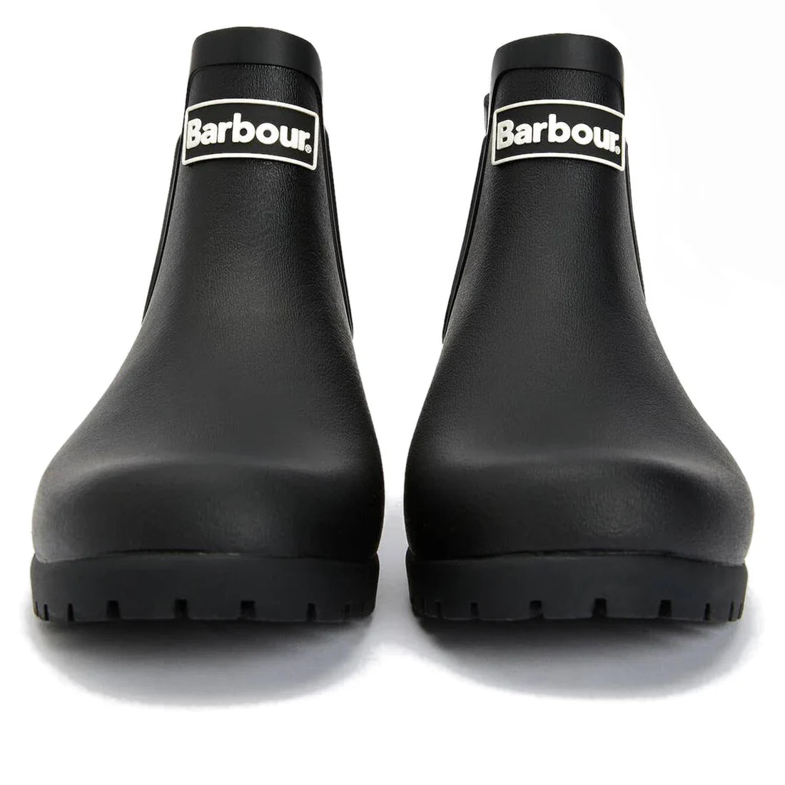 The Barbour Wilton Black Chelsea Wellingtons Women's Rainboot features a chunky sole, white Barbour logo on the shaft, and a classic tartan lining for added style—shown here from the front., 190375411423, 190375411546, 190375411614, 190375411768, 19037541