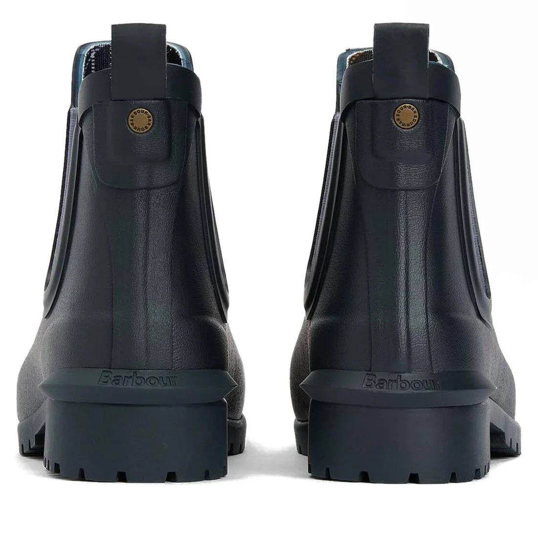 The Barbour Wilton Navy Chelsea Wellingtons Womens Rainboot is shown from the back, featuring thick ridged soles, pull tabs, a small round brass logo on each boot, classic Chelsea-style details, and signature tartan lining., 190375411744, 190375411867, 19
