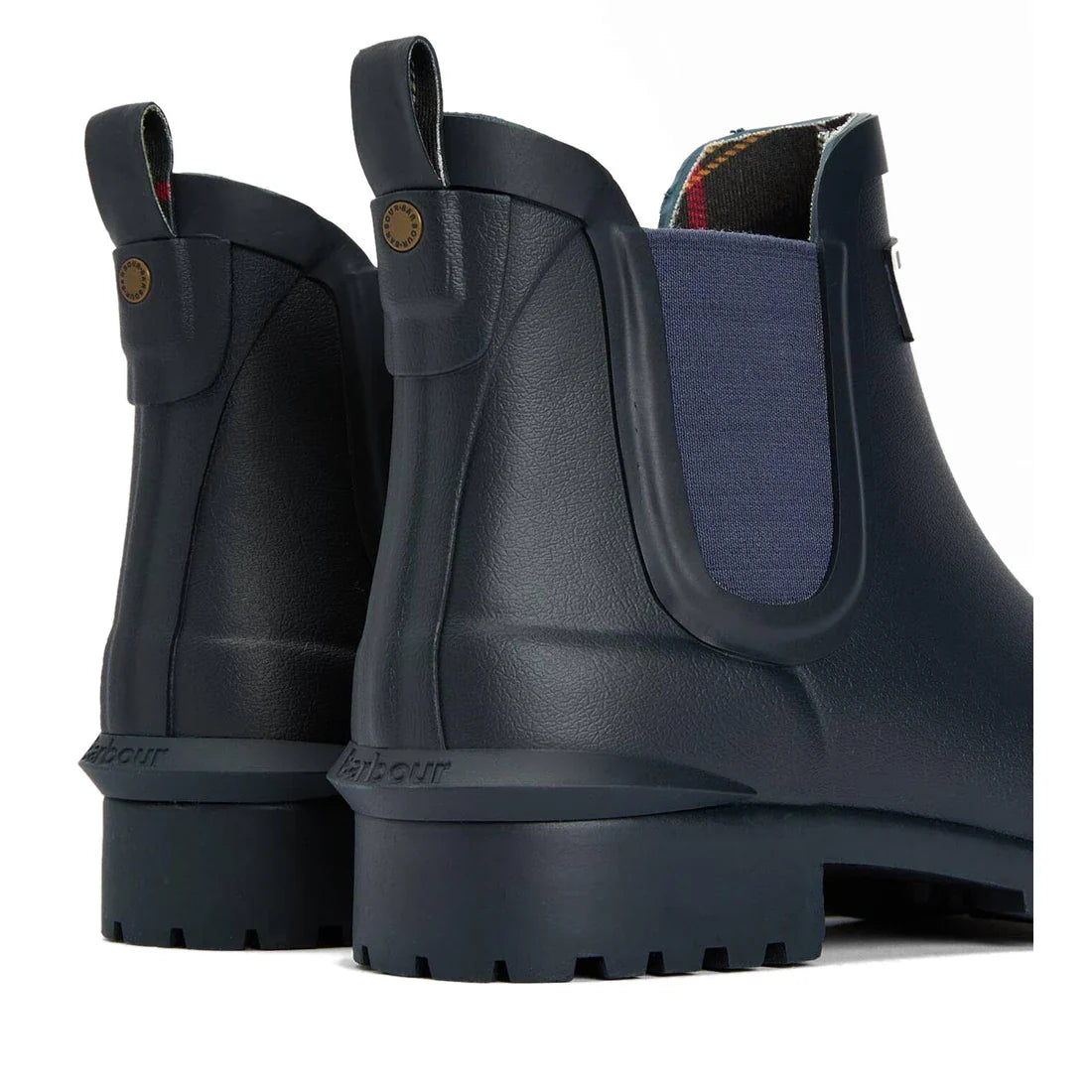 A close-up of Barbour Wilton Navy Chelsea Wellingtons Womens Rainboot shows two boots with tartan lining, side panels, pull tabs, and textured soles, highlighting the back and side details., 190375411744, 190375411867, 190375412055, 190375412123, 19037541