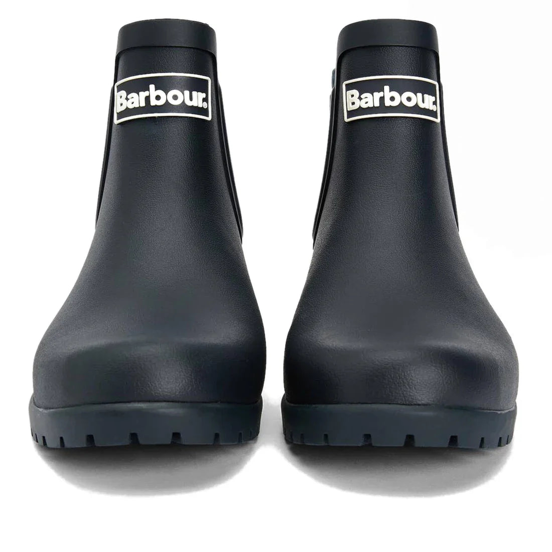 A pair of Barbour Wilton Navy Chelsea Wellingtons women's rain boots with chunky soles, shown from the front. These navy ankle boots feature a white Barbour logo patch on each shaft., 190375411744, 190375411867, 190375412055, 190375412123, 190375412222, 5