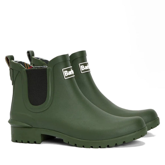 The Barbour Wilton Olive Chelsea Wellingtons Womens Rainboot features black elastic side panels, a front Barbour logo, rugged sole, back pull tab, and signature Barbour tartan lining for style and comfort.