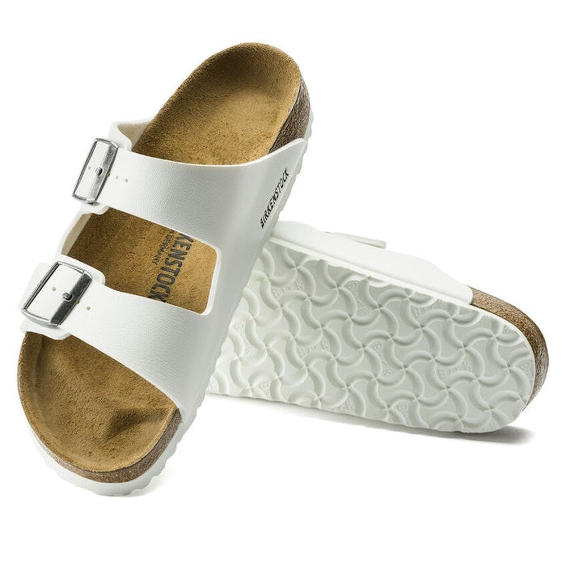 a pair of Birkenstock Arizona Birko Flor White Narrow Width with double straps, one over the foot and one over the toes with buckle adjustment. Staps are linked at the sides of the foot. Synthetic straps and a suede leather footbed,