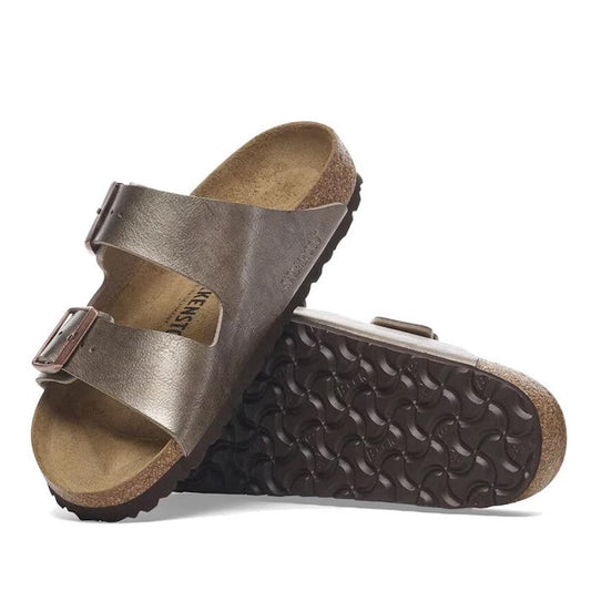 A pair of Birkenstock Arizona Birko Flor sandals in a pearlised Taupe color with 2 adjustable straps and a contoured cork-latex footbed.