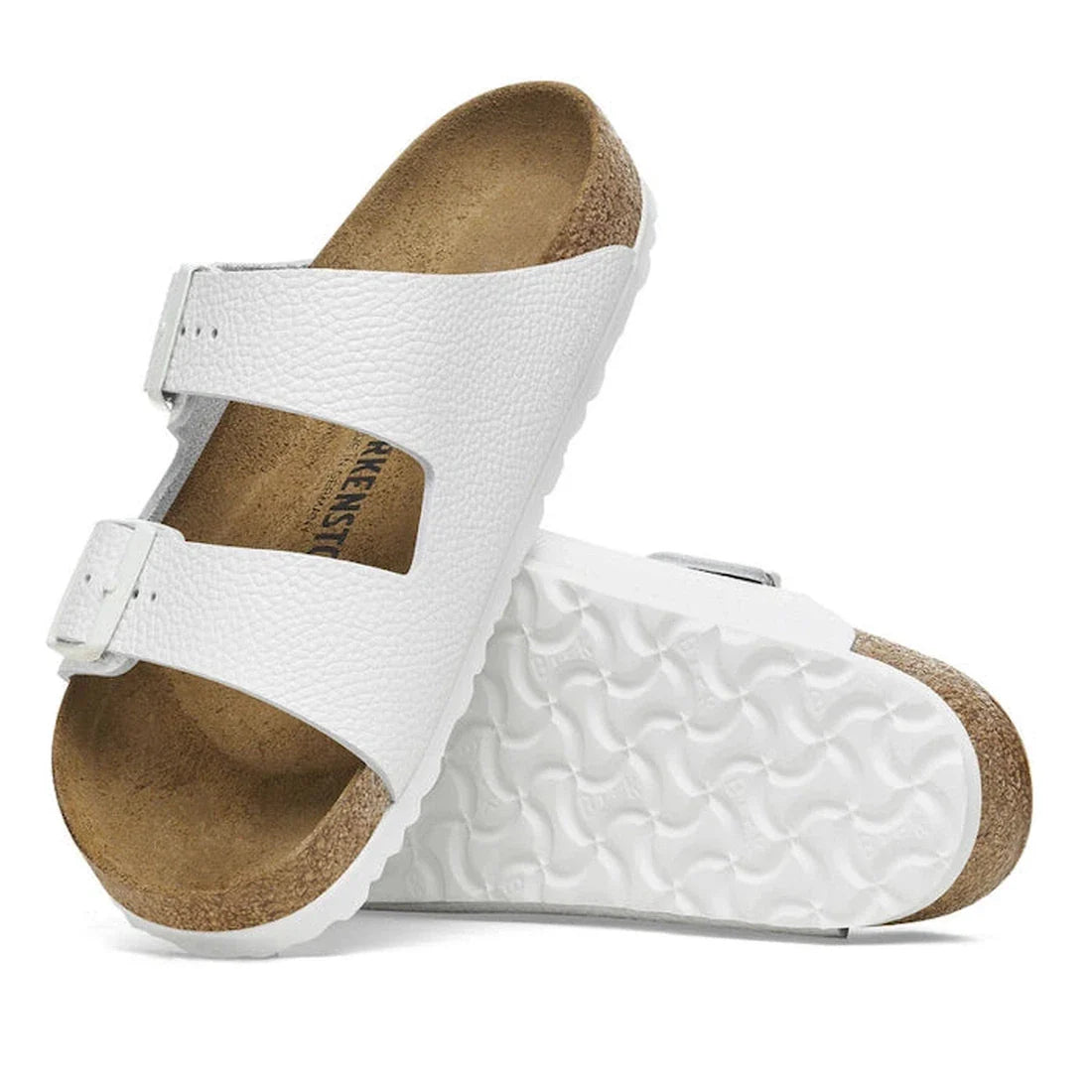 a pair of Birkenstock Arizona Smooth (Pebbled) Leather White Regular Width with double straps, one over the foot and one over the toes with buckle adjustment. Staps are linked at the sides of the foot. Leather thick straps and a suede leather footbed,