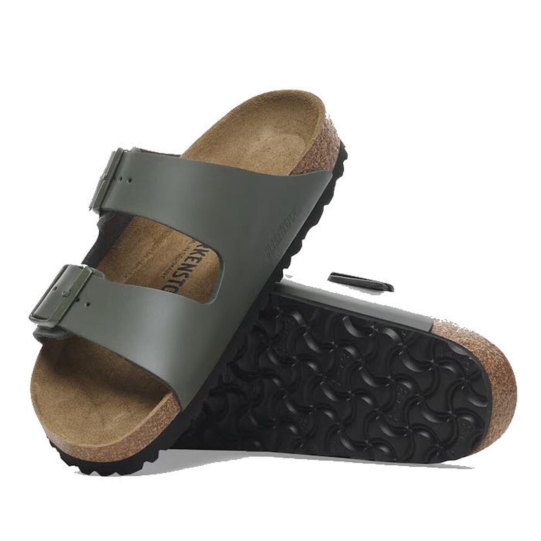 A pair of Birkenstock Arizona Smooth Leather Thyme (Regular Width) sandals with adjustable two-strap design and cork soles; one sandal stands upright while the other rests on its side, showing the sole.