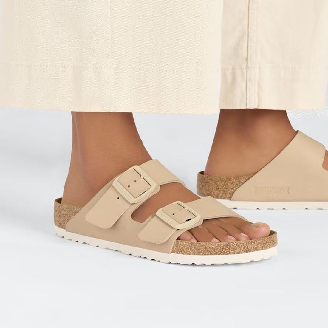 Beige sandals worn with a light-colored skirt on a white background,
4066648430384,
4066648430421,
4066648430469,, 45662, 4066648430346, 4066648430384, 4066648430421, 4066648430469, 4066648430506, 45668, 45669, 45670, 45671, 45672, 45673