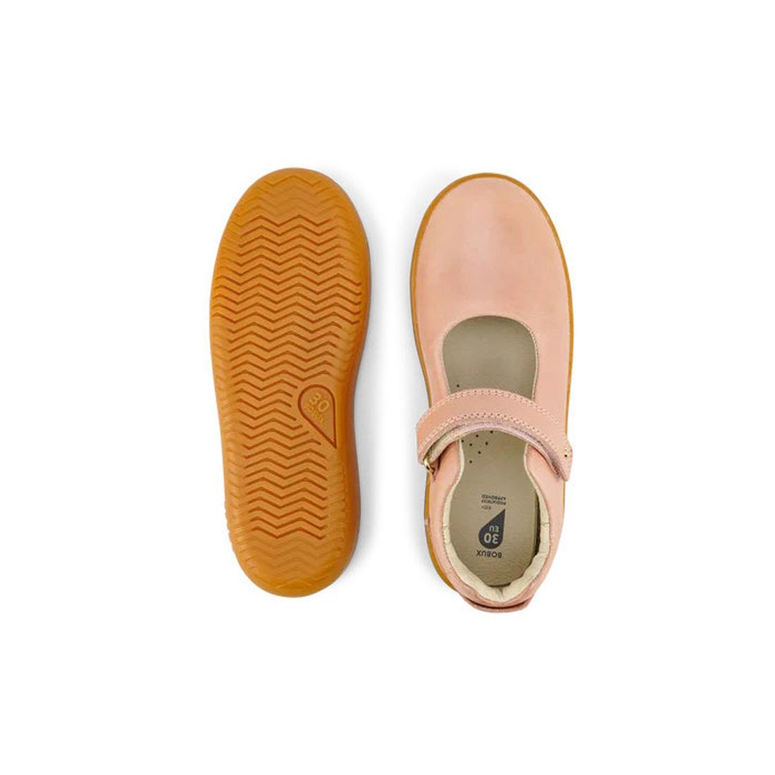 The Bobux Kid+ Delight Mary Jane Dusk Pink 831625Z are children’s pink leather shoes: one shoe shows the strap and top view, the other highlights the textured tan rubber sole—a timeless classic for girls., 9420075719187, 9420075719194, 9420075719200, 9420