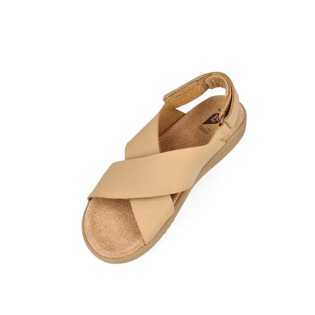 The Bobux Kid+ Plus Glide Parchment Beige Open Toe Sandal features wide crisscross straps, an adjustable Velcro heel strap, cushioned textured footbed, and flat sole, all shown against a white background for a stylish and comfortable kids’ option., 942007