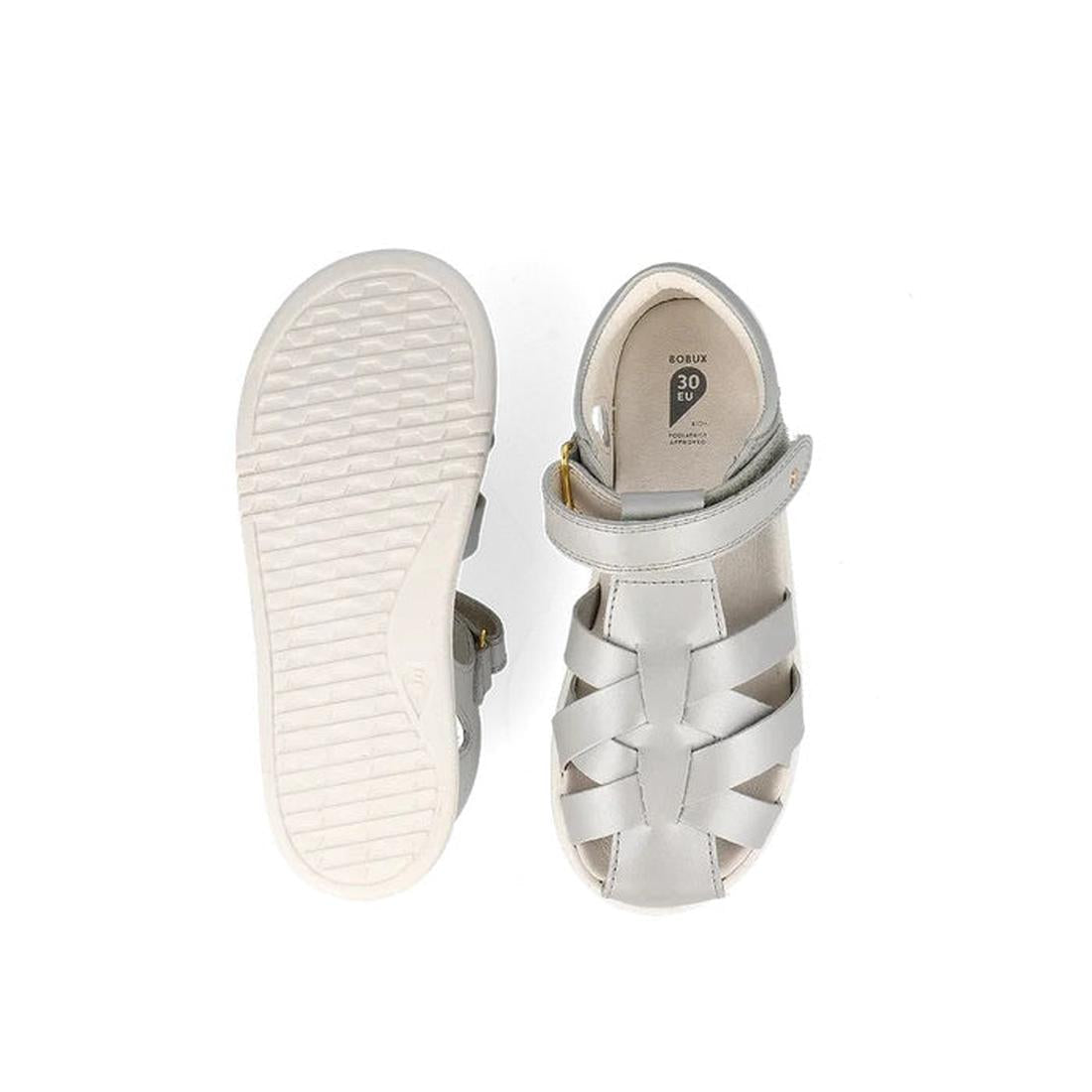 A pair of Bobux Kids Plus KP Tropicana II Metallic Silver Quick Dry Sandals (838320) shown from above and below: one highlights the woven upper and ankle strap; the other displays the textured rubber sole and inner size label., 9420075778146, 942007577332