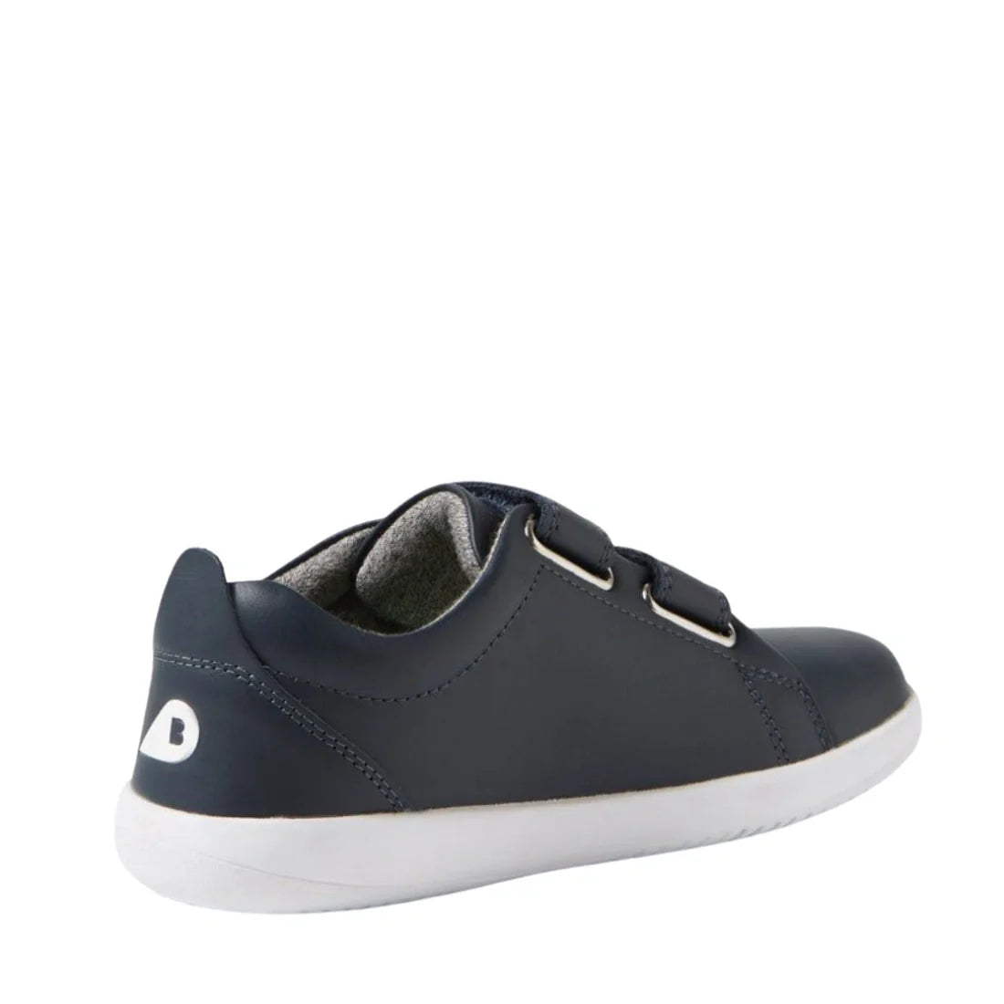 The Bobux KP Kids Plus Grass Court 2 II Leather Sneaker in Navy features a dark blue leather upper, two adjustable Velcro straps, a white sole, and a small white heel logo, shown angled from the back left., 9420074831255, 9420074831262, 9420074831279, 942