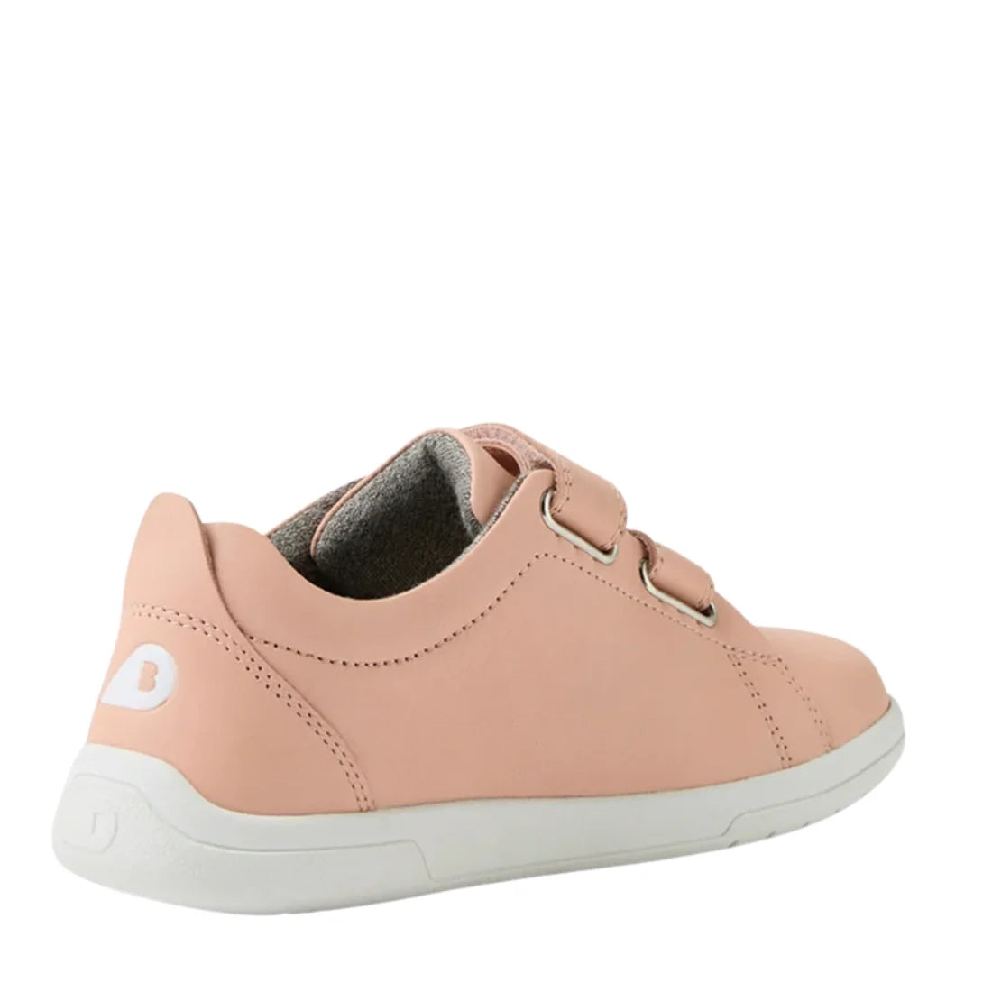 The Bobux KP Kids Plus Grass Court 2 II Leather Sneaker in Seashell is a light pink kids' shoe with two adjustable Velcro straps, a white sole, and a white B logo on the heel, shown from the back on a plain white background., 9420074831538, 9420074831545,