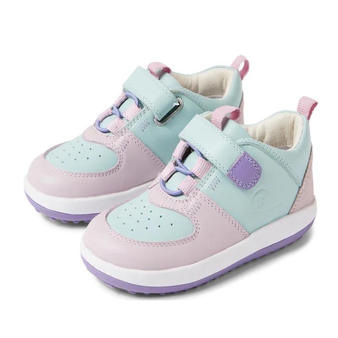 The Bobux Kid+ BackSpin Leather Mid Boot Sneaker 853005 in Keepsake Purple features pastel leather panels, purple soles, elastic laces, Velcro straps, and a lightweight EVA midsole for all-day comfort.