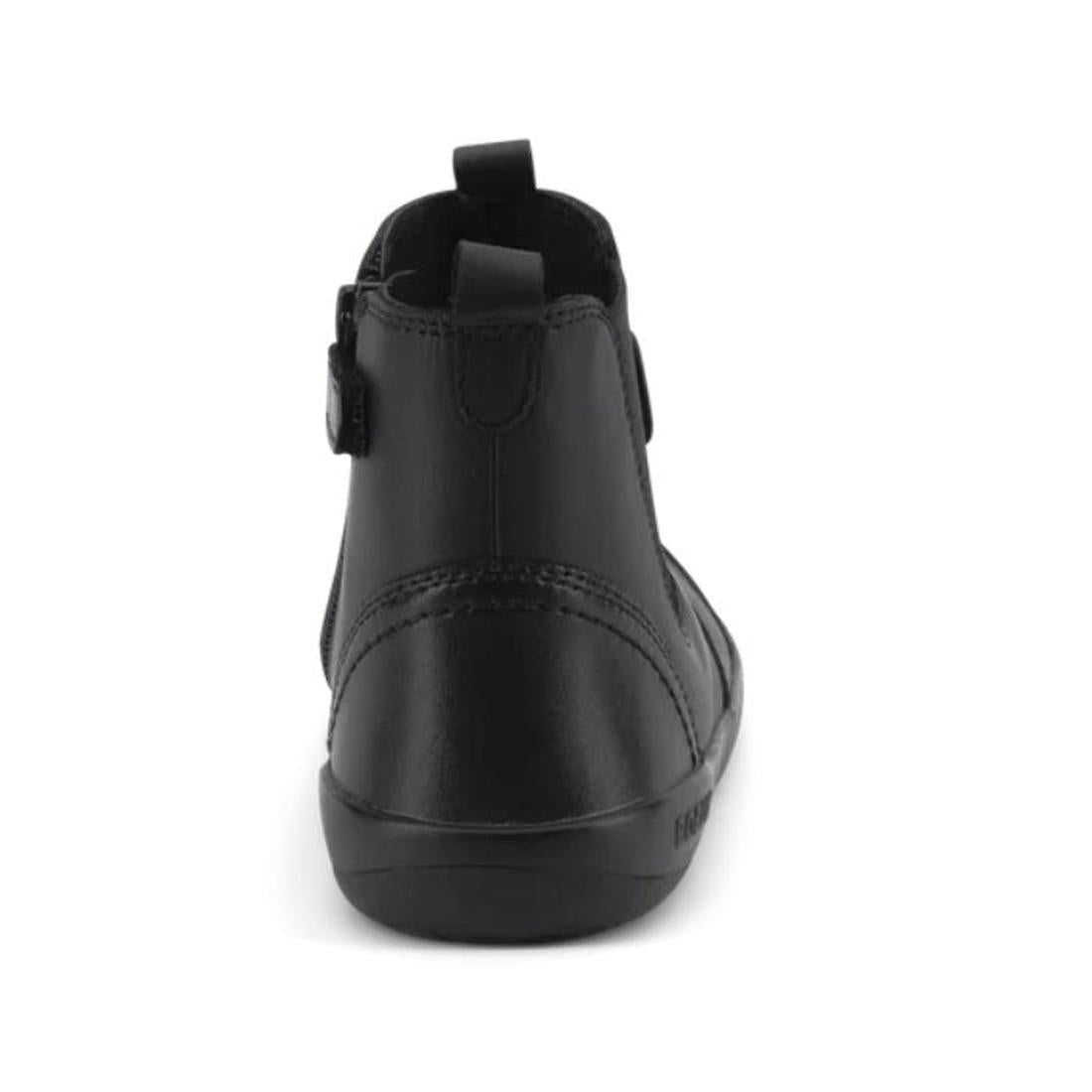 The Bobux Kid+ Black School Leather Boot Jodphur Black Sole Shoes is an ankle-high black leather boot, shown from the back with a top pull tab and visible stitching along the heel and sole, set against a white background., 27690, 9420071306183, 9420071306