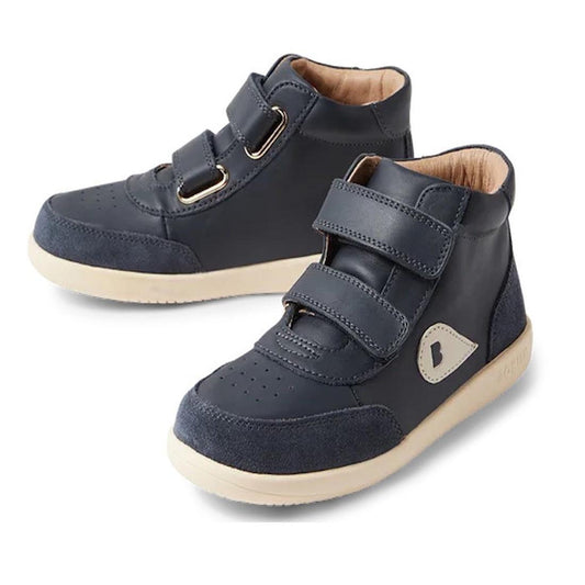 The Bobux Kids Plus KP Champ Hi Boot Navy 851008 is a dark blue high-top trainer with beige soles, light brown lining, two Velcro straps per shoe, ankle support, and a small light-colored side patch.