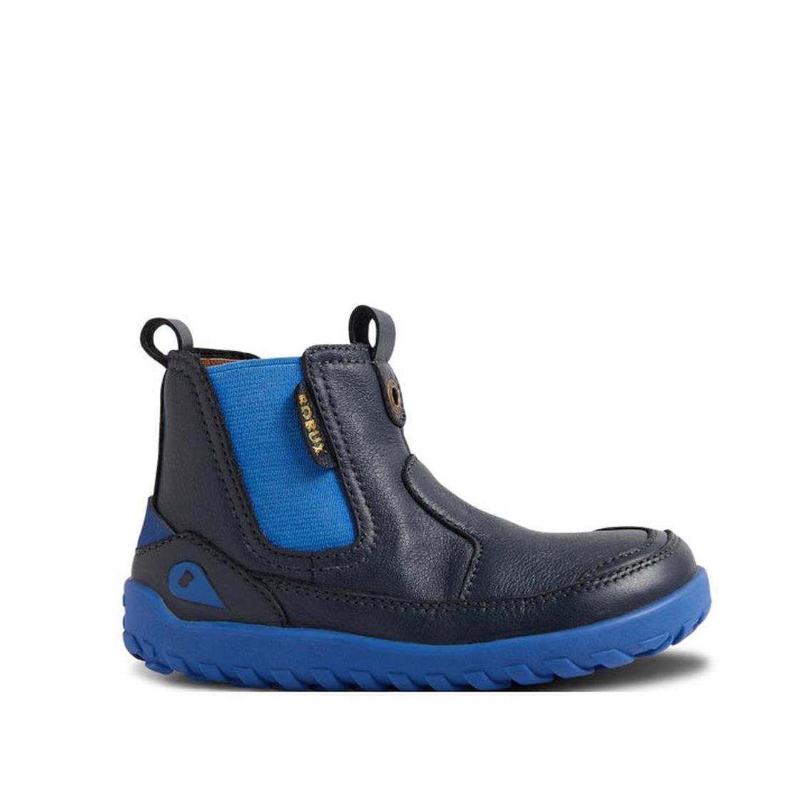 The Bobux IW Iwalk Trail Leather Boot Navy Alpha is a kids’ leather boot in navy, with a barefoot-shaped toe box, bright blue elastic side panel, blue pull tabs, blue rubber sole, visible stitching, and a small fabric side label., 9420068563568, 942006856