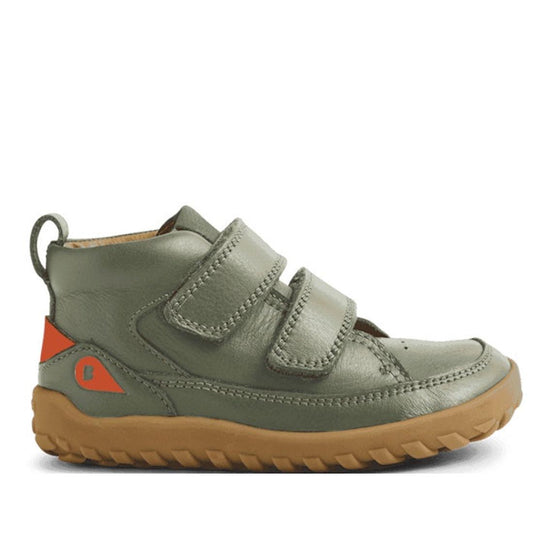 The Bobux IW Iwalk Trek Leather Boot Vetiver Green Alpha features a barefoot-shaped toe-box, brown rubber sole, two Velcro straps, heel pull tab, and orange accents—ideal for active kids seeking comfort and natural movement outdoors.