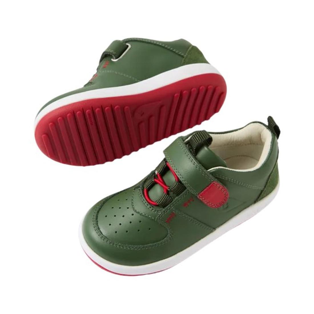 The Bobux IW Iwalk Backspin Leather Boot in Bronze Green is shown—one from the side, one highlighting its red tread. Both kids’ sneakers feature red elastic laces, a hook-and-loop strap, and red soles for easy fastening and bold style., 9420074818072, 942