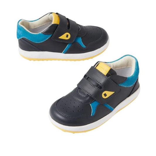 The Bobux IW Iwalk Baseline Leather Mid Sneaker Navy is a pair of kids’ leather sneakers with black uppers, blue and yellow accents, yellow tabs, white soles, and double hook-and-loop strap closure.