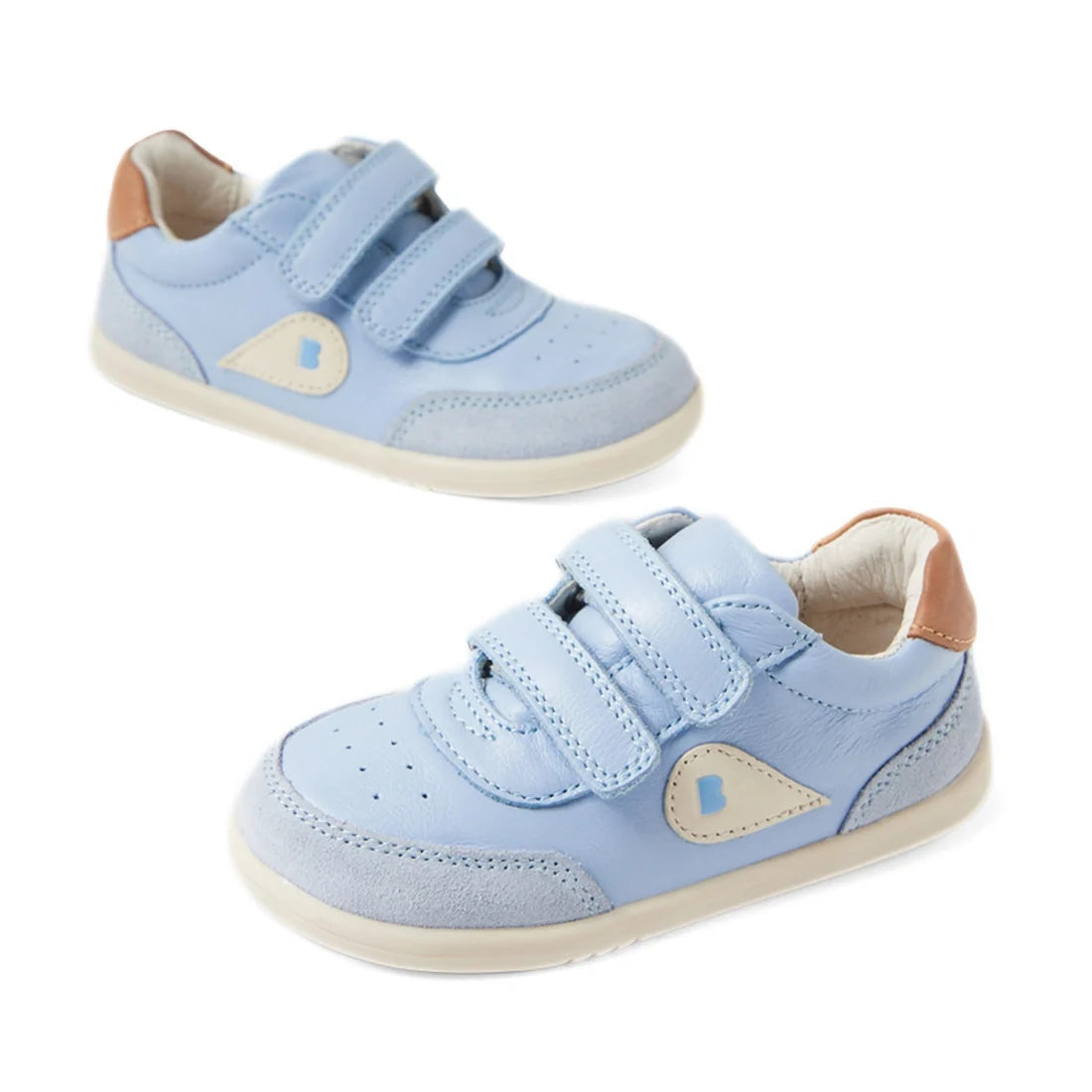 A pair of Bobux IW Iwalk Toddlers Champ Leather Sneaker in Skyway Blue, featuring light blue leather uppers, beige soles, tan heel accents, hook-and-loop straps, and a white and beige decorative patch on the sides.