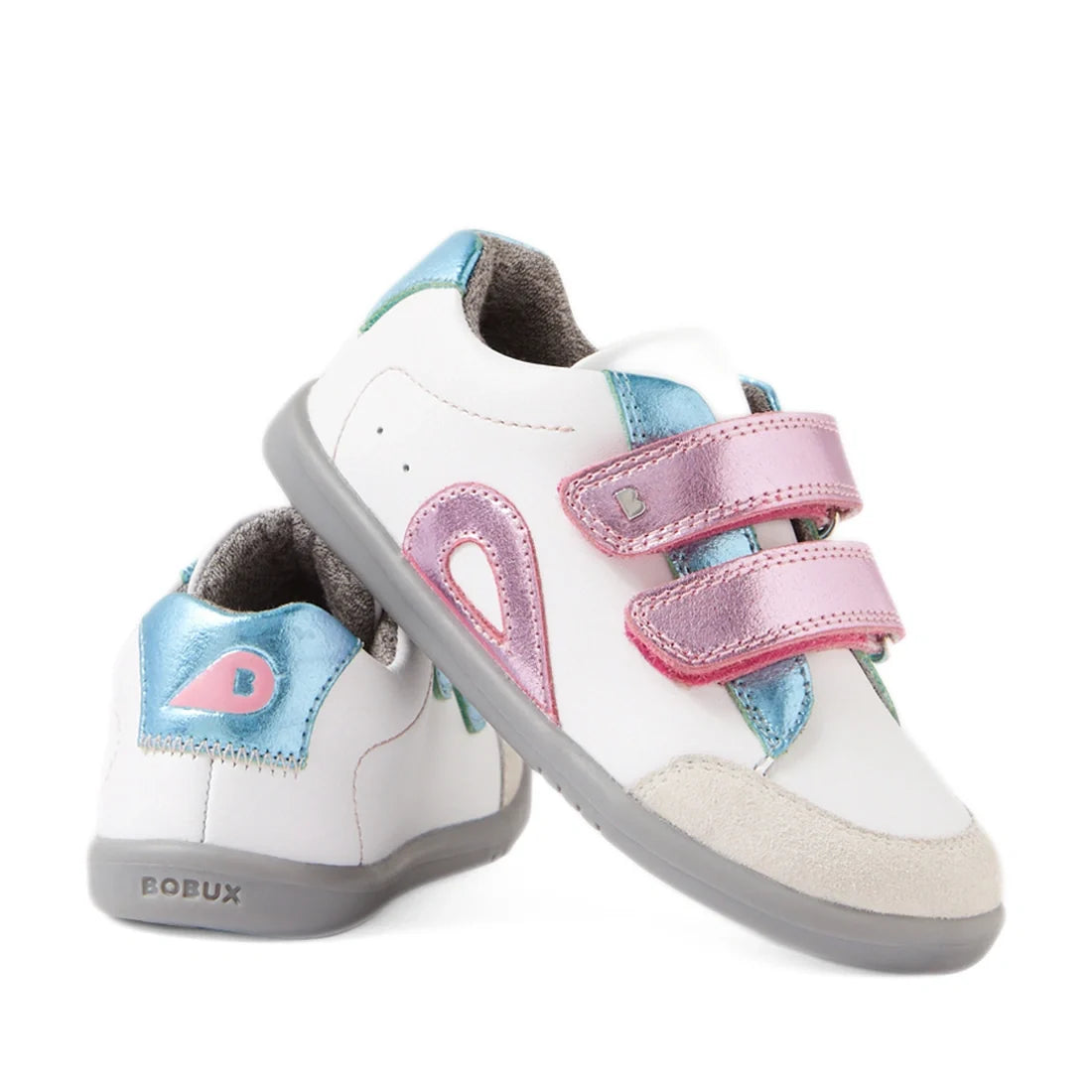 Two white Bobux IW Iwalk Blaze Toddlers Leather Sneakers in Pink Metallic feature gray soles, blue and pink metallic accents, and double pink Velcro straps. One shoe stands upright while the other leans against it, displaying the BOBUX branding on the hee