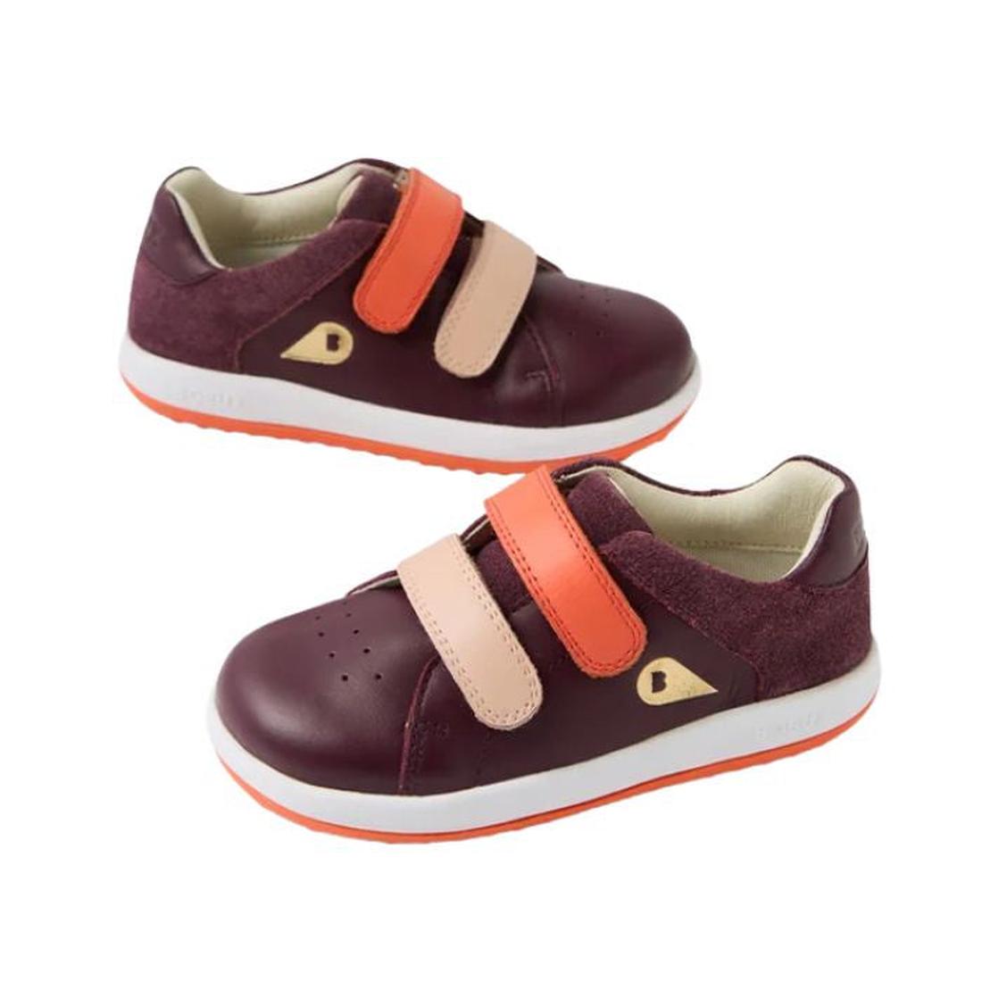 The Bobux IW Iwalk Breakpoint Leather in Fig Purple are children’s casual sneakers with two velcro straps, orange soles, small gold side accents, and are shown on a plain white background.