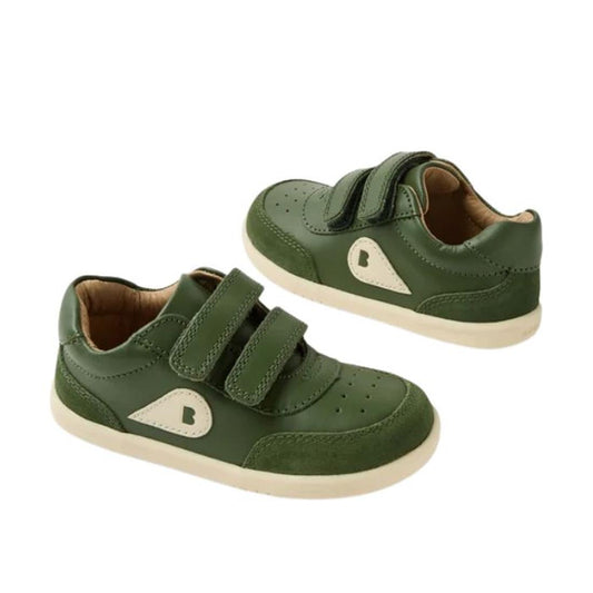 The Bobux IW Iwalk Champ Sneaker Bronze Green features green leather, two adjustable hook-and-loop straps, beige soles, and a beige B logo on the side, designed for toddlers.