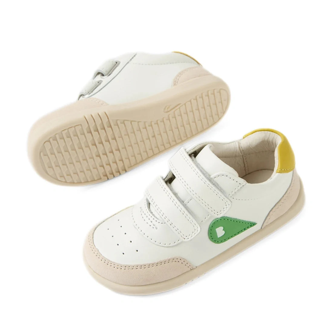 Two Bobux IW Iwalk Toddlers Champ Leather Sneakers in White Green—featuring white leather uppers, beige soles, green side accents, yellow heel details, and hook-and-loop straps for closure—are displayed on a white background., 9420074856609, 9420074856616