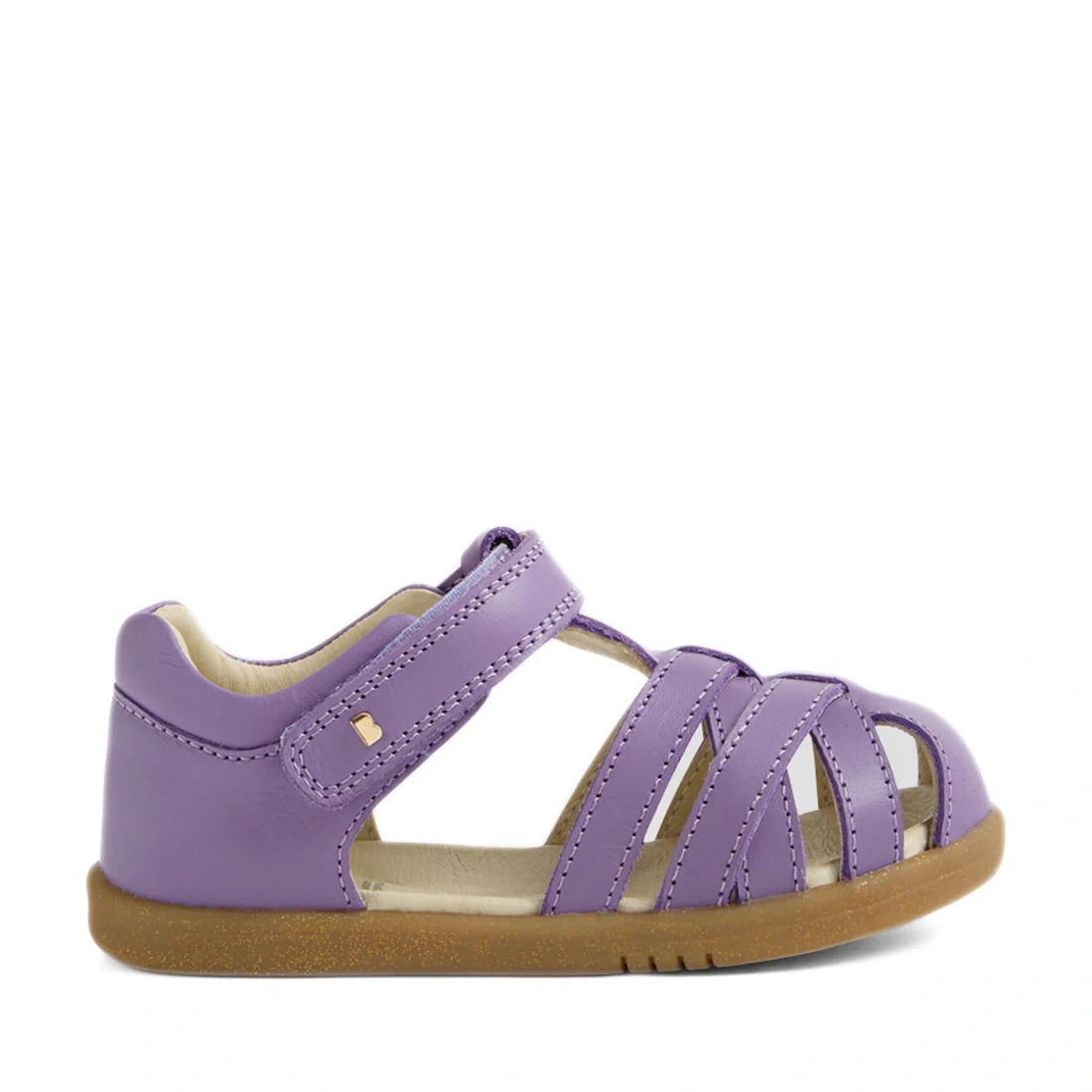 The Bobux Iwalk IW Cross Jump Toddlers Purple Haze Leather Sandal features a closed heel and open toe, with multiple straps across the foot for secure comfort. Styled in a classic kids’ leather sandal design, it includes an adjustable Velcro strap closure