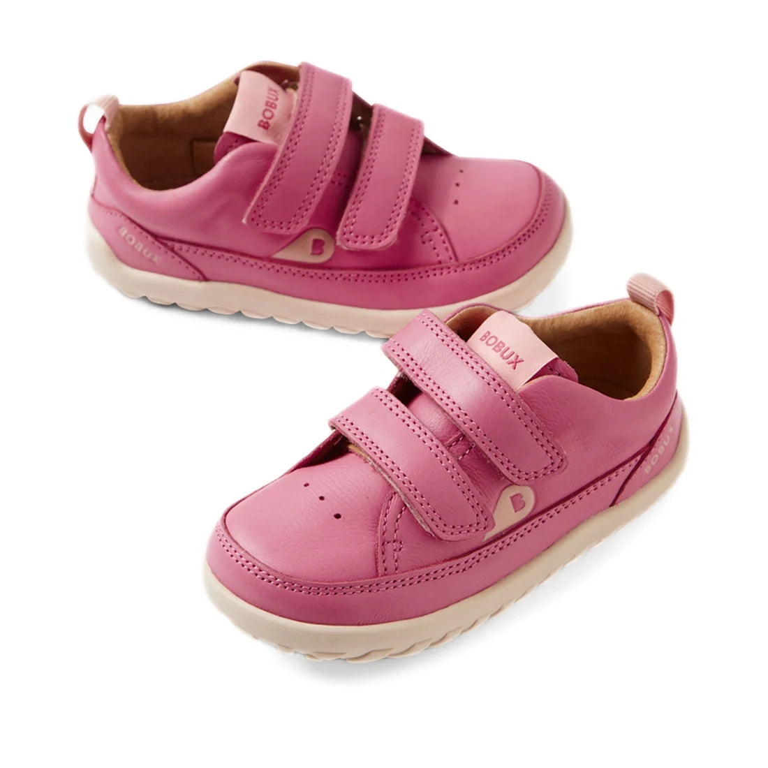 A pair of Bobux IW Iwalk Dawn Toddlers Leather Sneakers in Cashmere Rose Pink, crafted from leather with two velcro straps, white zero drop soles, displayed on a white background.