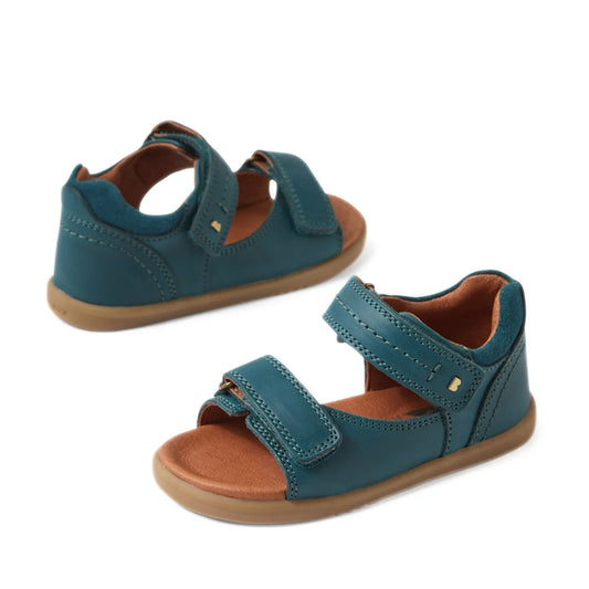 A pair of Bobux IWalk Driftwood Sandal Mediterrainean Green open-toe sandals with brown soles, velcro straps, and cushioned brown insoles, displayed on a white background—perfect toddler boys’ leather sandals for everyday comfort and style.