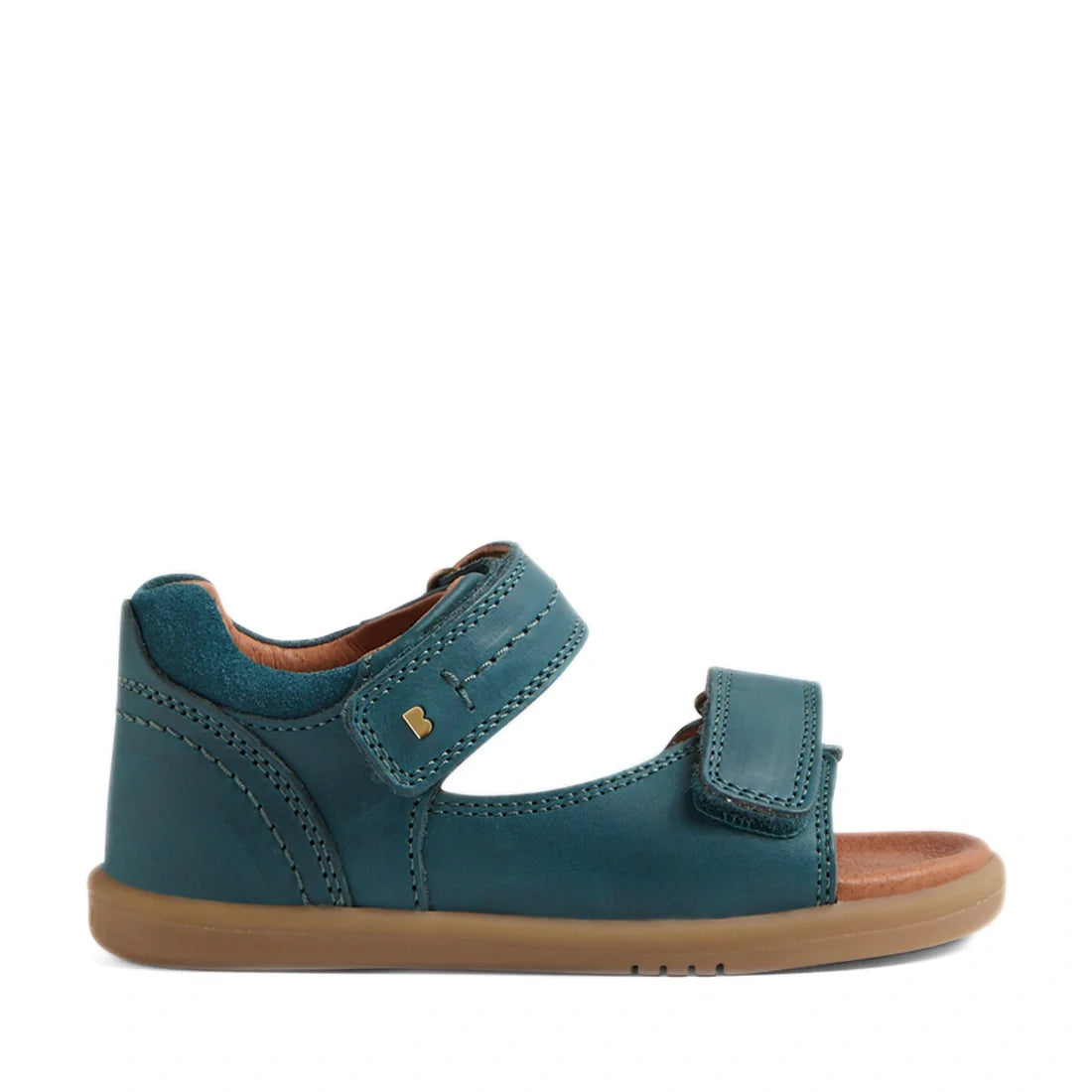The Bobux IWalk Driftwood Sandal in Mediterrainean Green is a toddler boys’ open-toe leather sandal featuring two adjustable Velcro straps, a tan lining, and a light brown rubber sole. Shown in side profile against a white background, this design takes in