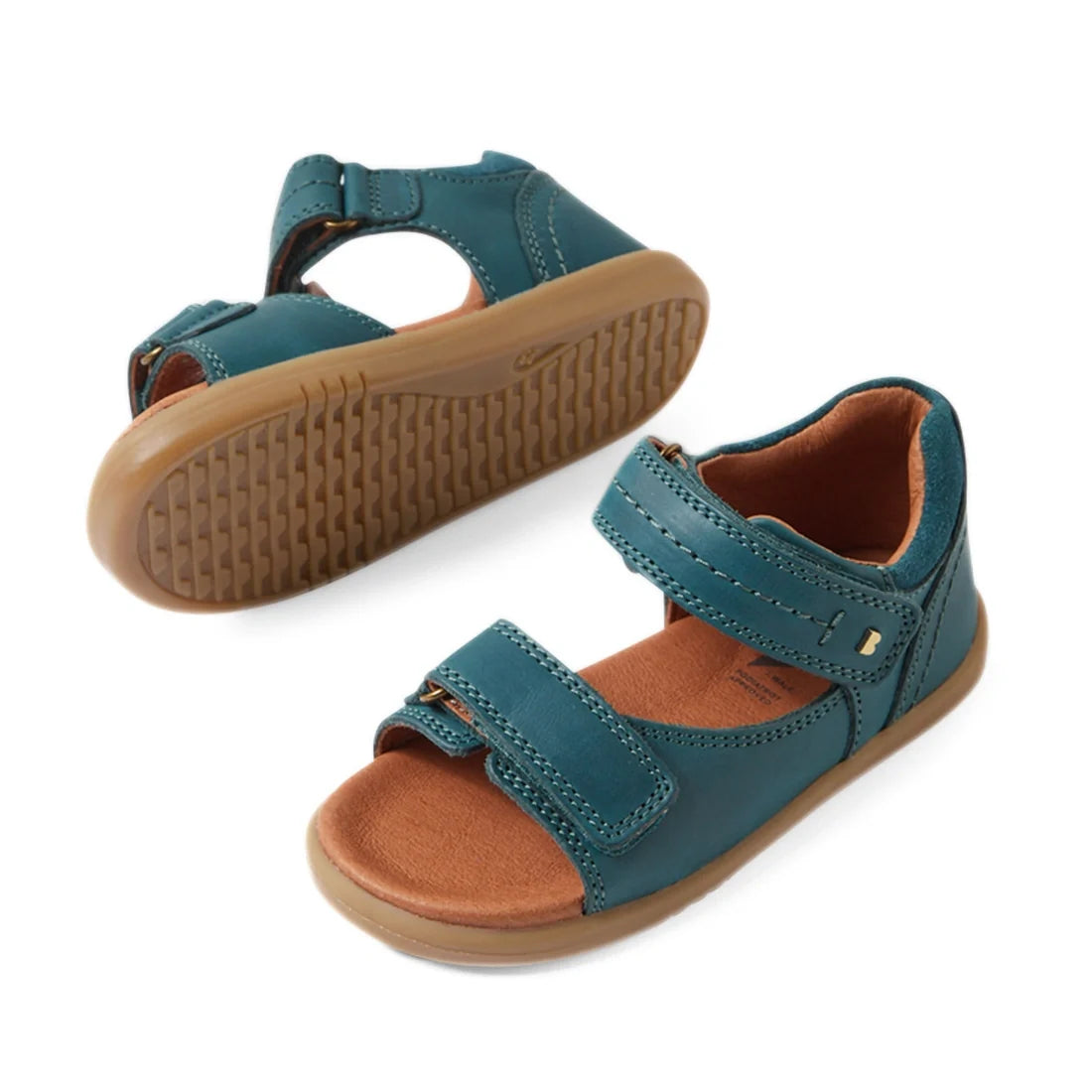 Two Mediterranean green open-toed sandals with brown soles and adjustable Velcro straps, shown from the side and bottom angles on a white background; these stylish Bobux IWalk Driftwood Sandal Mediterrainean Green Open Toe toddler boys’ leather sandals of