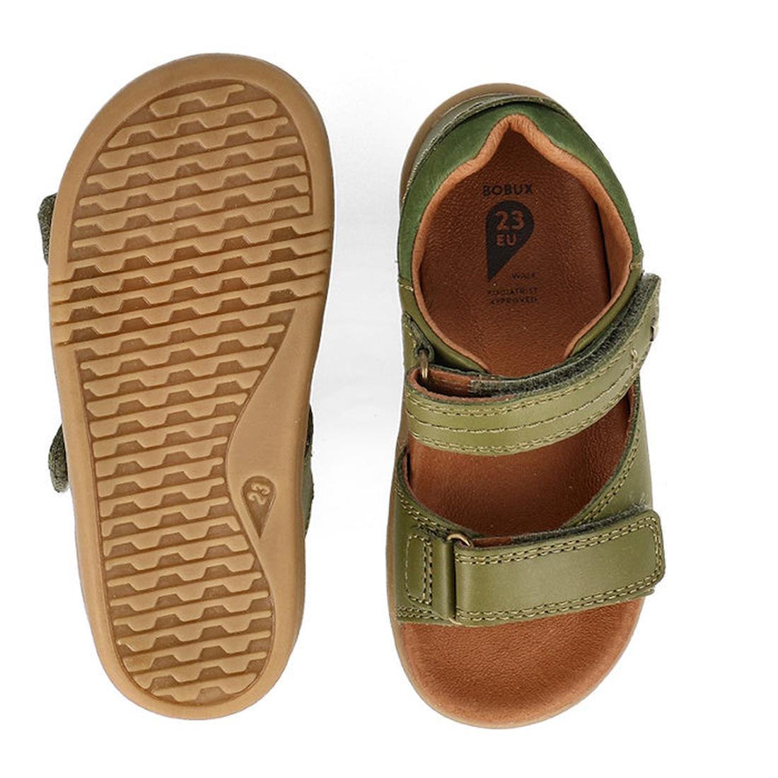 The Bobux Kid+ Plus Driftwood Sea Kelp Green Open Toe Sandal 833518 features two adjustable straps, brown rubber soles with a textured tread, and “23 EU” size marking inside. One sandal is shown from the top and one from the bottom., 9420075774575, 942007