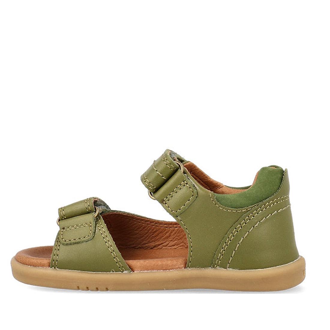 The Bobux Kid+ Plus Driftwood Sea Kelp Green Open Toe Sandal 833518 for kids features two adjustable straps, a tan rubber sole, brown lining, and visible stitching on the green leather straps and heel. Shown from the side., 9420075774575, 9420075773530, 9