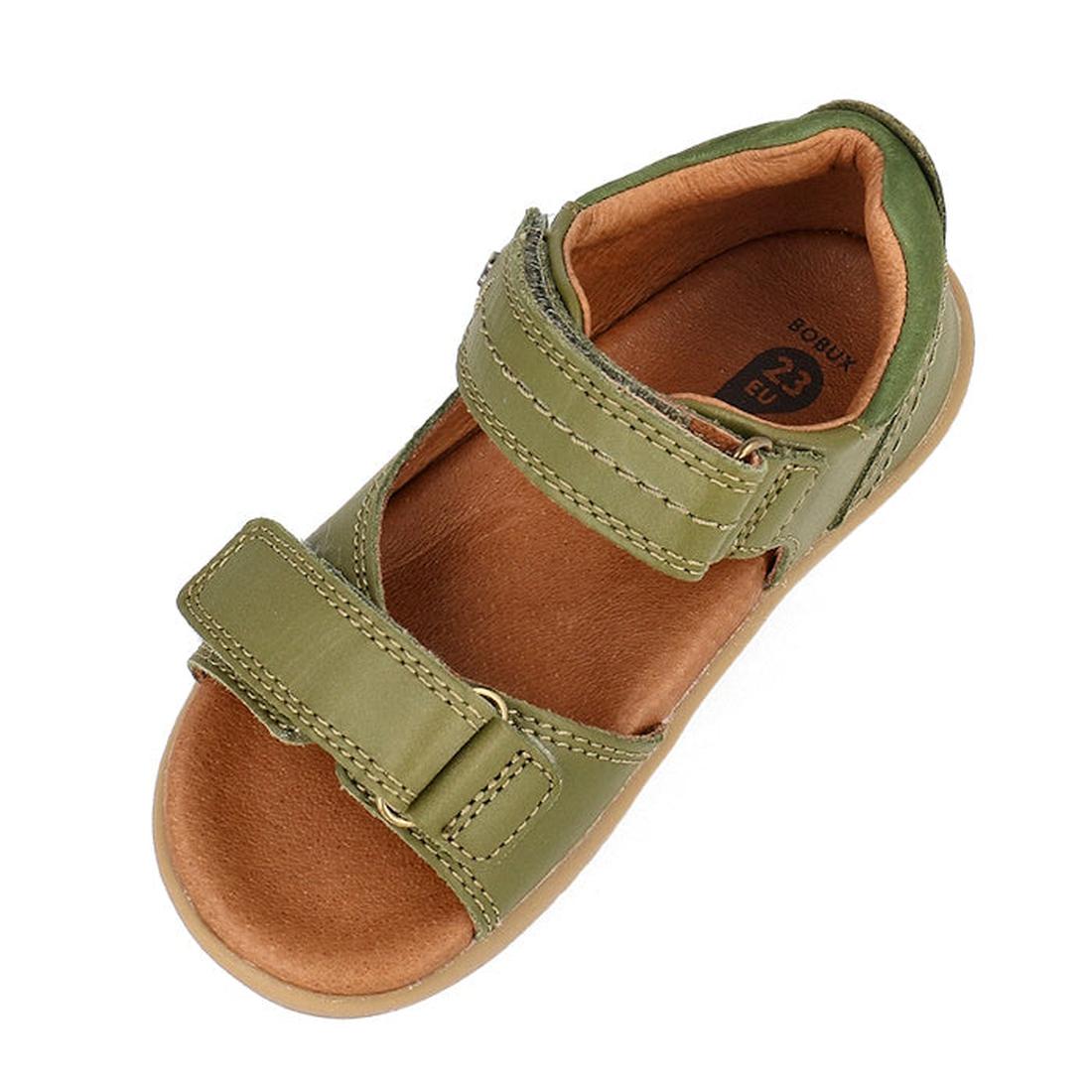 A single Bobux Kid+ Plus Driftwood Sea Kelp Green Open Toe Sandal 833518 for children, featuring two Velcro straps, a tan cushioned insole, and a rubber sole, shown from above., 9420075774575, 9420075773530, 9420075779457, 9420075773868, 9420075774872, 94