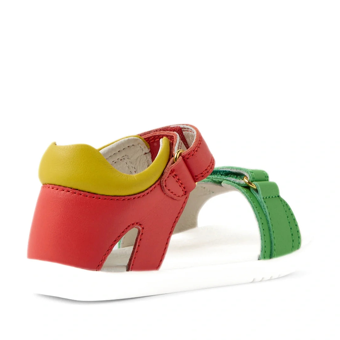 Introducing the Bobux IWalk Dune Toddlers Sandal Grenadine Red Open Toe—a vibrant and adventure-ready sandal for kids, showcasing red, green, and yellow leather straps with a white sole and adjustable closures. Shown from the back angle, these comfortable