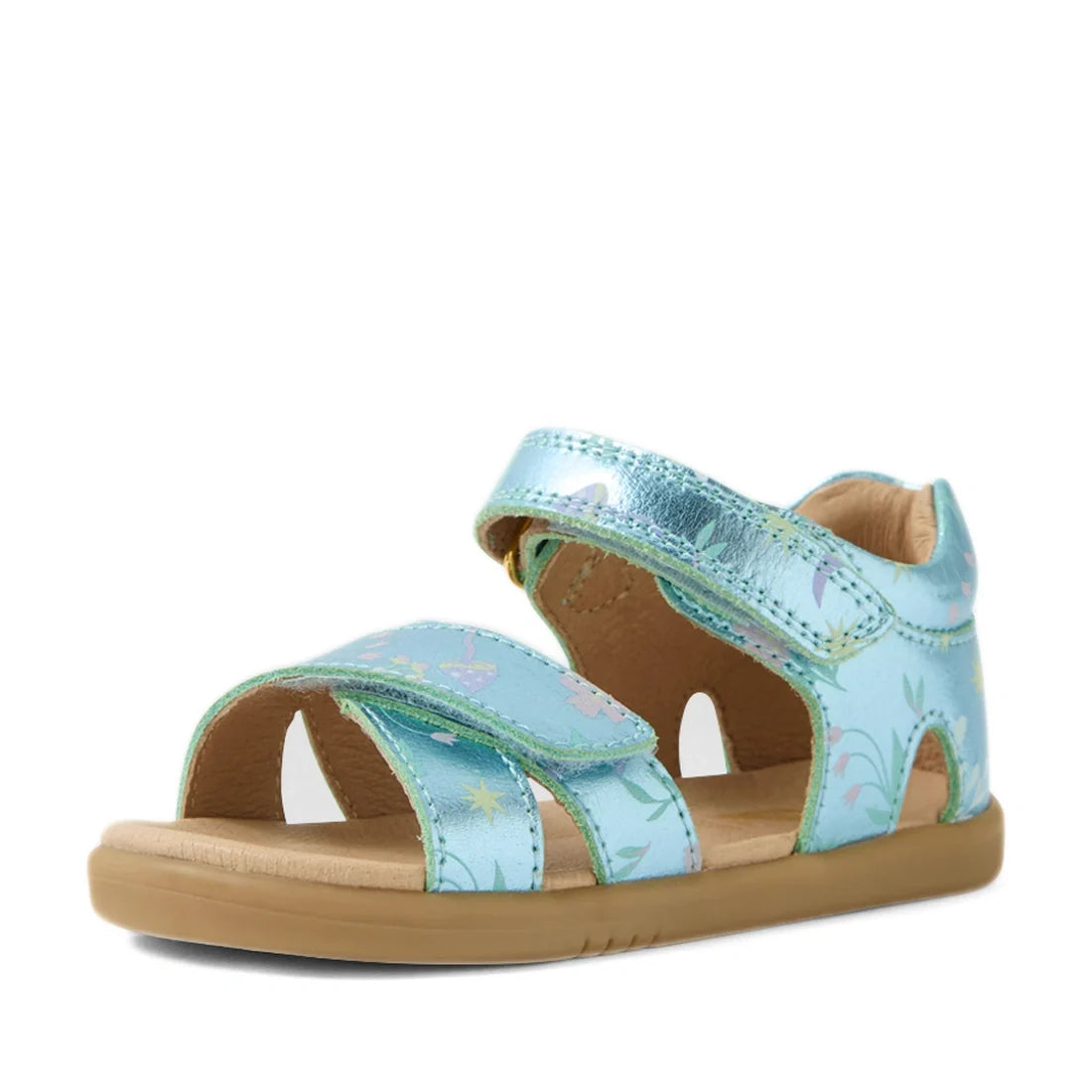 The Bobux IWalk Flora Toddlers Sandal in Jelly Mint Metallic Blue features an open toe, charming flower print, adjustable velcro straps, and a flat tan rubber sole. Shown on a white background, these sandals combine comfort and style for playful little on