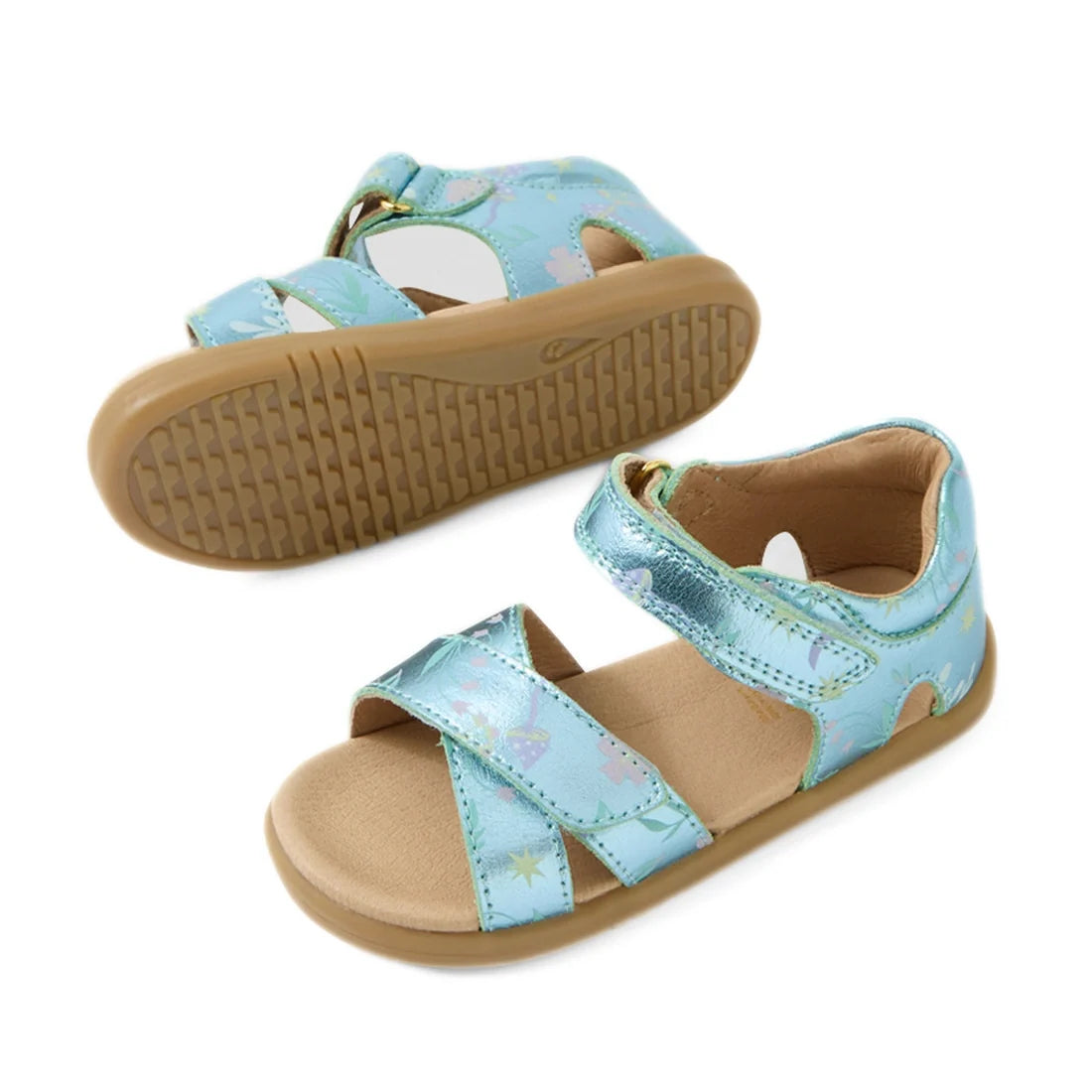 Two Bobux IWalk Flora Toddlers Sandal Jelly Mint Metallic Blue Open Toe sandals for children feature light blue straps, pastel star and rainbow patterns, tan footbeds, and rubber outsoles. One sandal is upright while the other is flipped to display the so