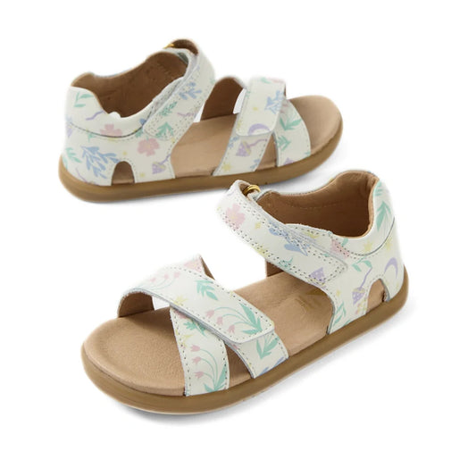 Two pairs of Bobux IWalk Flora Toddlers Sandal White Floral Open Toe are displayed, each featuring light-colored soles and white leather straps with a delicate floral pattern and adjustable Velcro closures. Crafted for all-day comfort, one sandal lies fla
