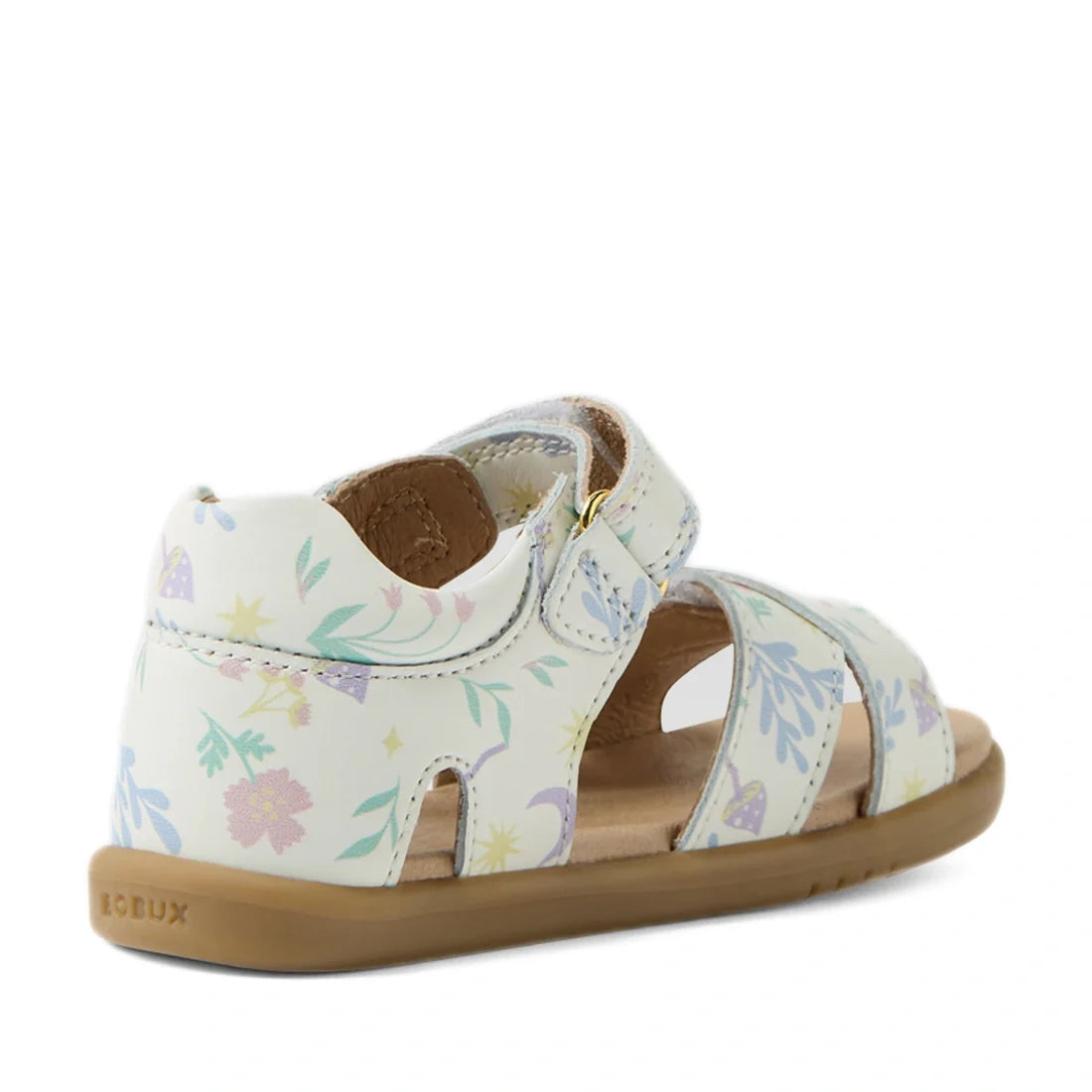 The Bobux IWalk Flora Toddlers Sandal in White Floral features pastel floral patterns, an open toe design, and a secure ankle strap. Crafted from soft and flexible leather with a light brown sole, the sandal is displayed at an angle to showcase both the b
