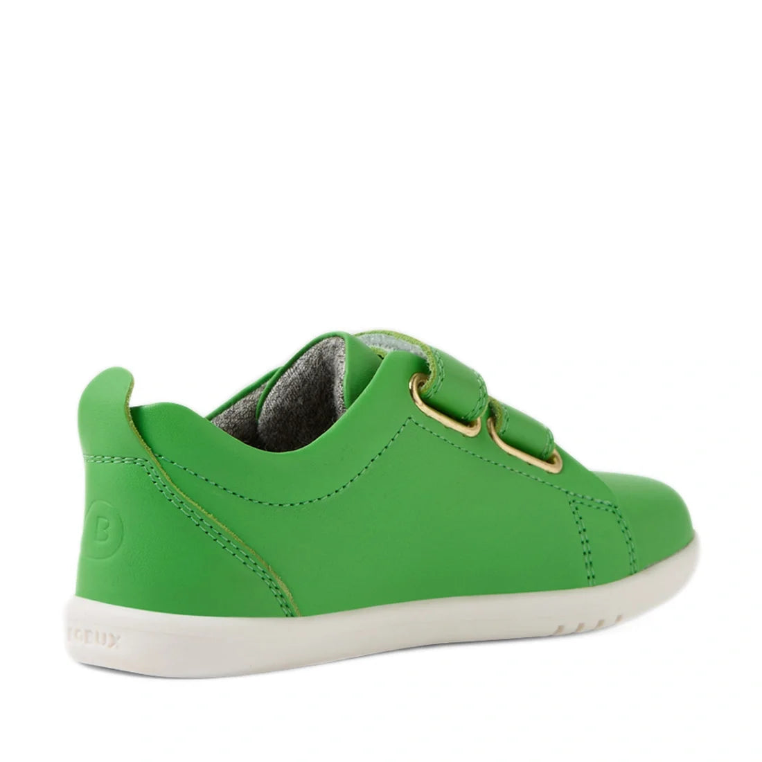 A back-left angled view of the Bobux Iwalk Toddlers Grass Court Retro Green Leather Trainer, featuring a green leather upper, white sole, gold eyelets, and two hook-and-loop straps—ideal for fans of the iconic Grass Court style., 9420074806789, 9420074806