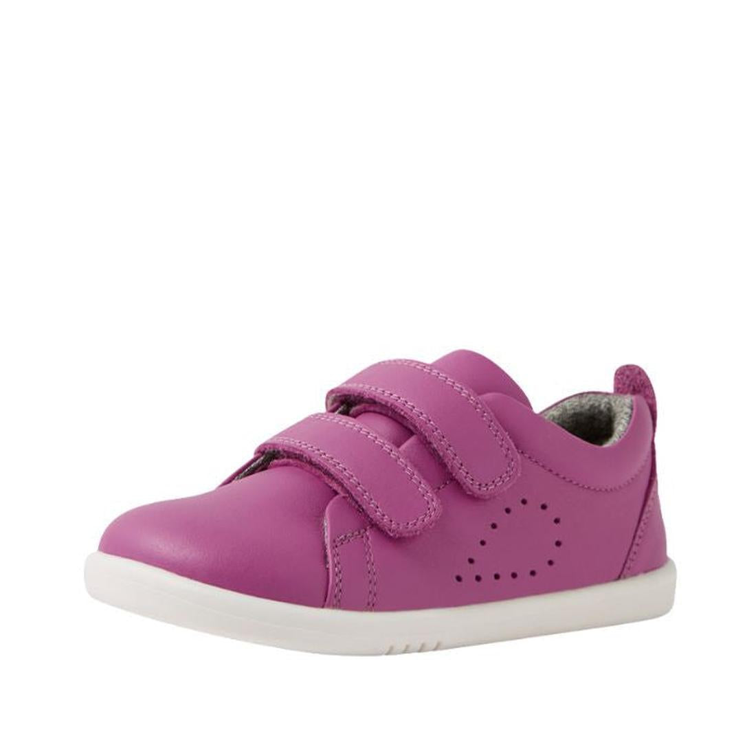 The Bobux IW Iwalk Grass Court Leather Sneaker in Cattleya Orchid Purple is a toddler shoe with double straps, white sole, and side perforations, shown solo against a white background.