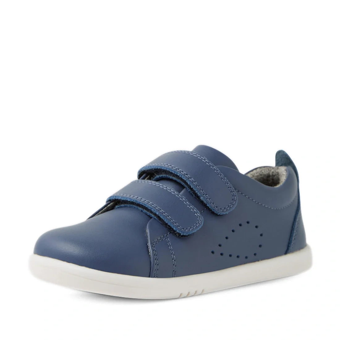 A Bobux Iwalk Toddlers Grass Court Vintage Indigo Blue Leather Trainer featuring two Velcro straps, a white sole, and decorative side stitching is displayed against a white background—ideal for parents looking for stylish and durable kids’ leather sneaker