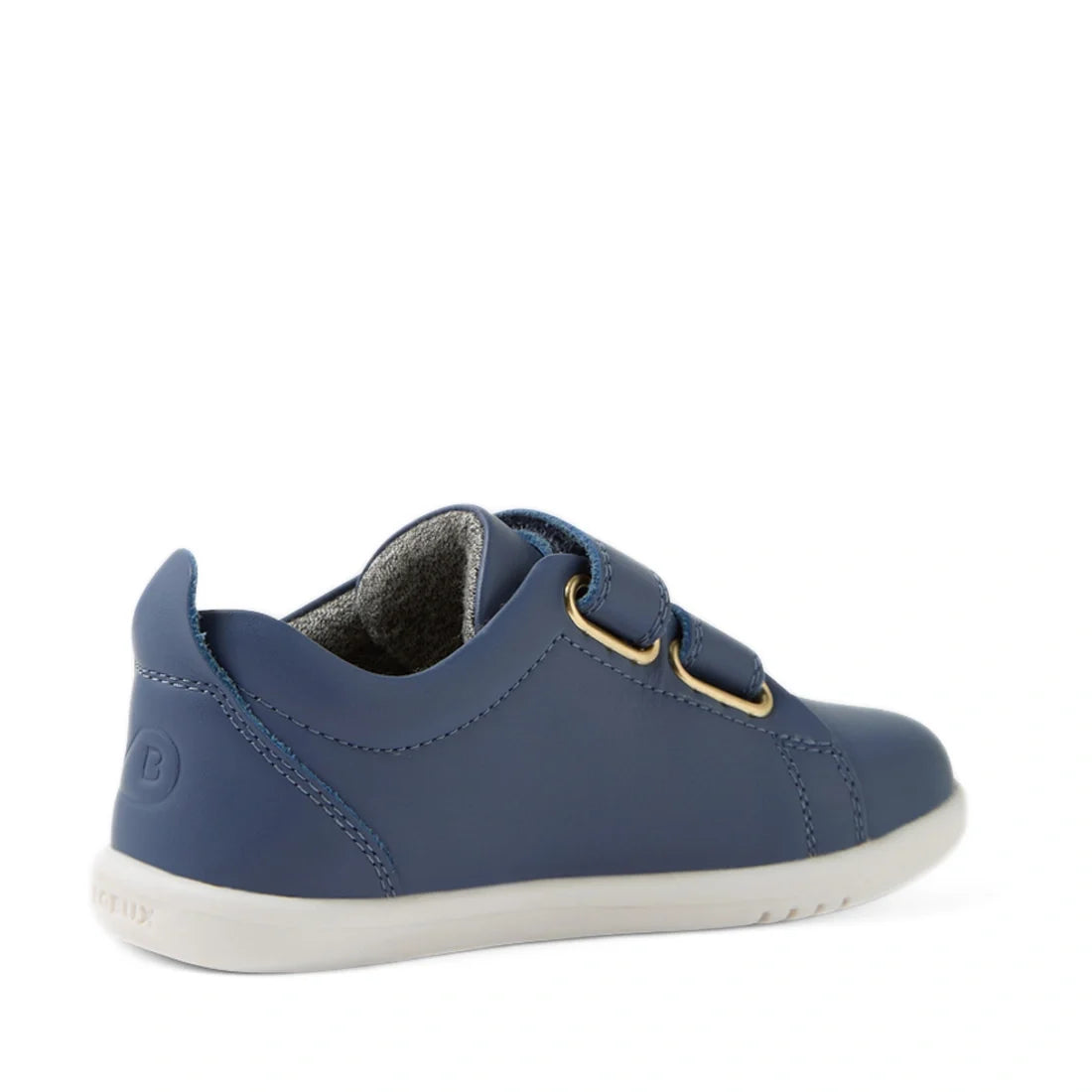 A Bobux Iwalk Toddlers Grass Court Vintage Indigo Blue leather trainer with two Velcro straps and a white sole, displayed angled to the side and back against a white background., 9420074806680, 9420074806697, 9420074806703, 9420074806710, 9420074806727
