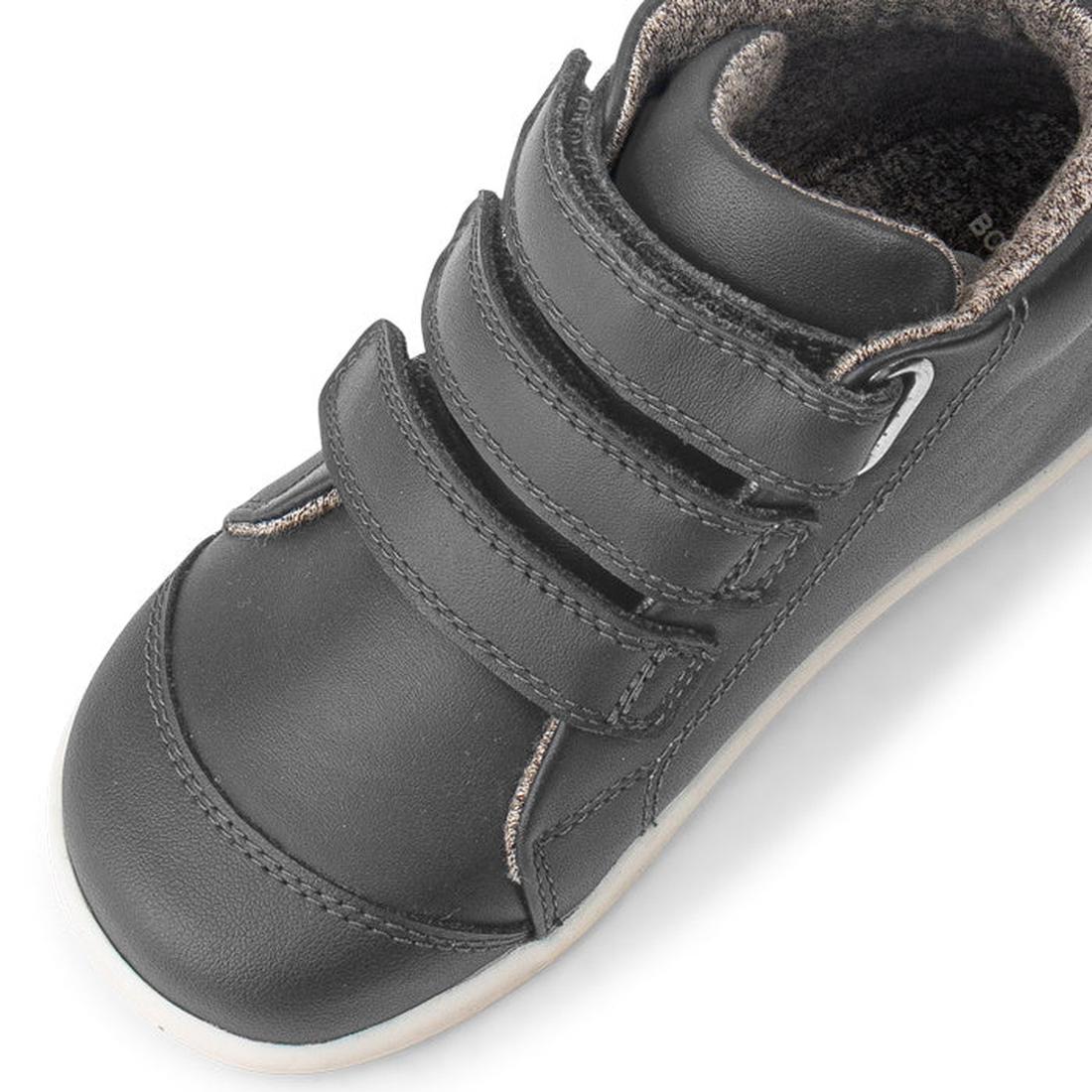 A close-up of the Bobux IWalk IW Hi Court Boot in Smoke Grey shows a premium coated leather children's shoe with three Velcro straps, visible stitching, a light sole, and a soft textured lining., 9420071306299, 9420071306305, 9420071306312, 9420071306329,