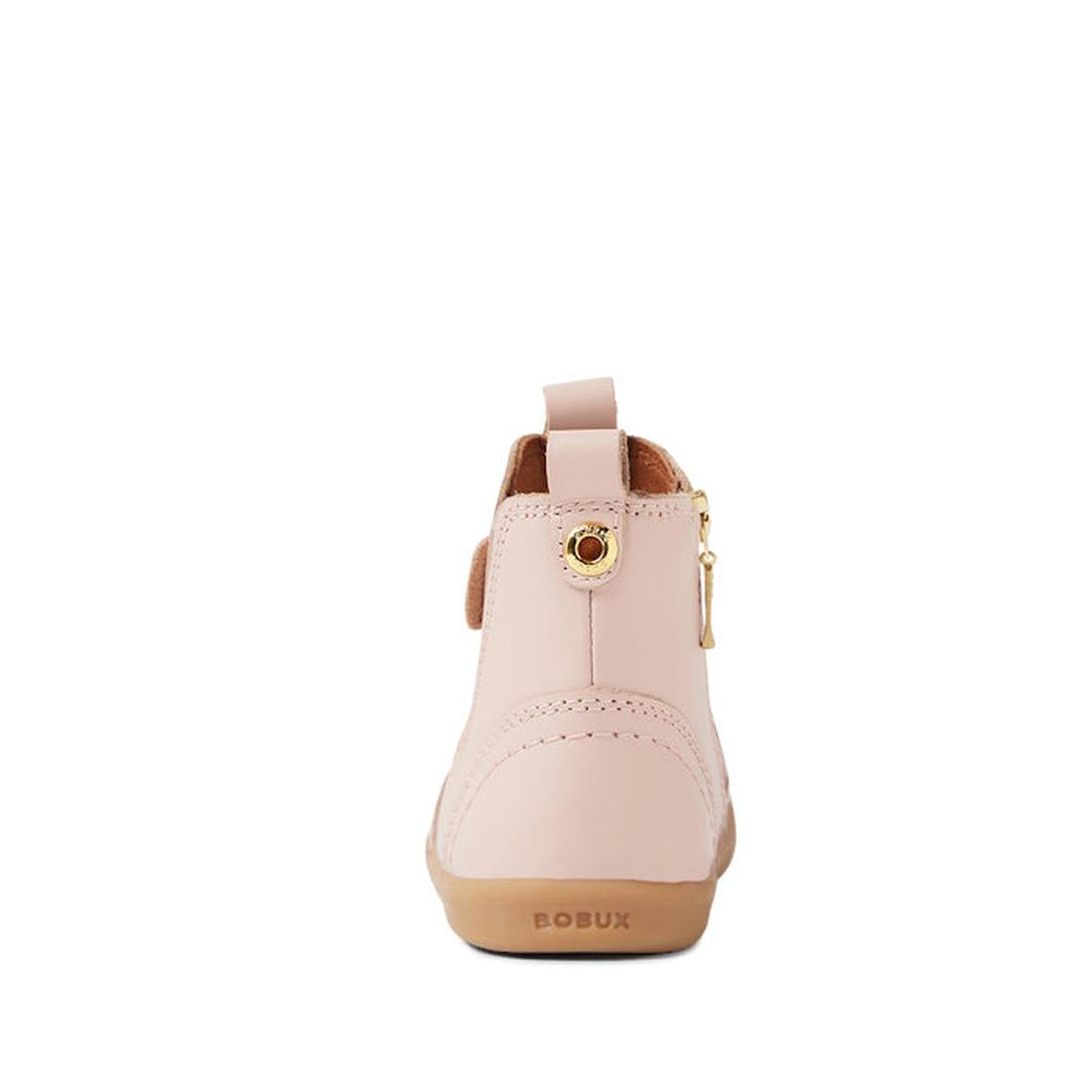 The Bobux IW Iwalk Jodhpur Leather Boot in Cameo Rose Pink is a toddler leather boot with a pull tab, side gold zipper, BOBUX branding on the tan rubber sole, and is podiatrist-endorsed for healthy foot development., 9420068539617, 9420068539624, 94200685