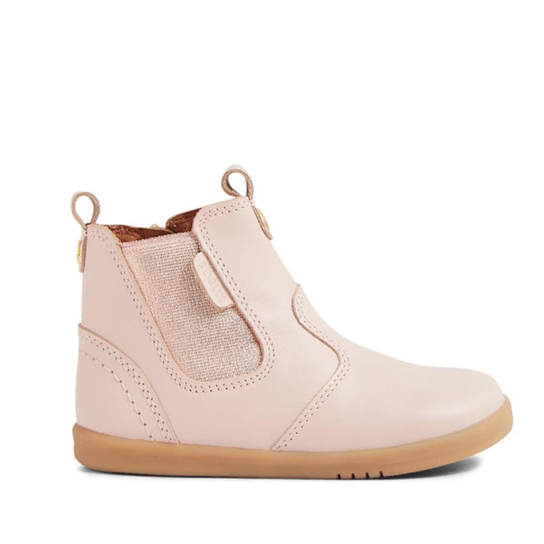 The Bobux IW Iwalk Jodhpur Leather Boot in Cameo Rose Pink is a podiatrist-endorsed kids’ ankle boot featuring light pink leather, tan elastic side panel, brown sole, pull tabs, and visible stitching., 9420068539617, 9420068539624, 9420068539631, 94200685
