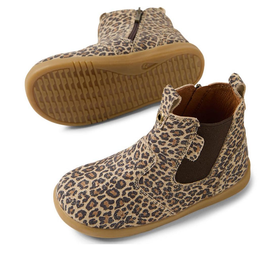 The Bobux IW Iwalk Jodhpur Leather Boot Leopard Shimmer features a brown sole, leopard print, side elastic panels, and zipper closure. One boot is upright; the other displays the textured sole. Podiatrist endorsed for little feet., 9420074802415, 94200748