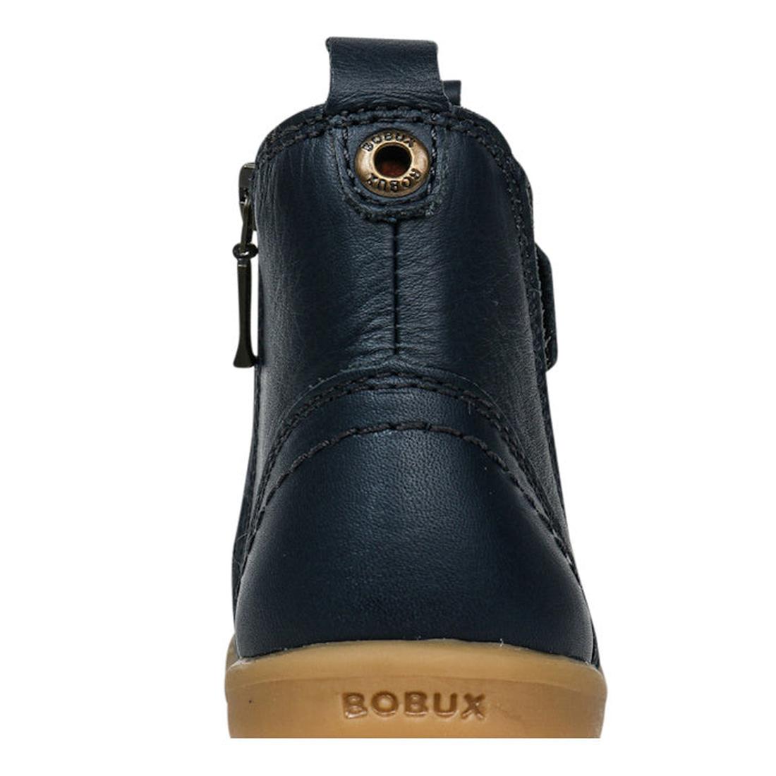A close-up rear view of the Bobux Iwalk Jodhpur Ankle Boots Navy 620825A—stylish navy blue children’s leather boots with a beige rubber sole, side zipper, and BOBUX branding—perfect for everyday adventure., 9420062046623, 9420062046630, 9420062046647, 942